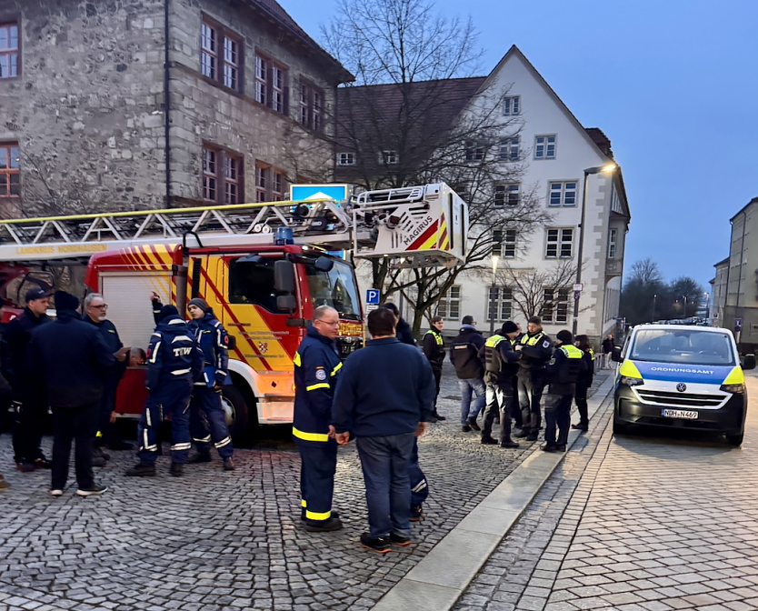 Bild: Personen und Einsatzfahrzeuge von Polizei und Feuerwehr am Nordh&auml;user Rathaus
