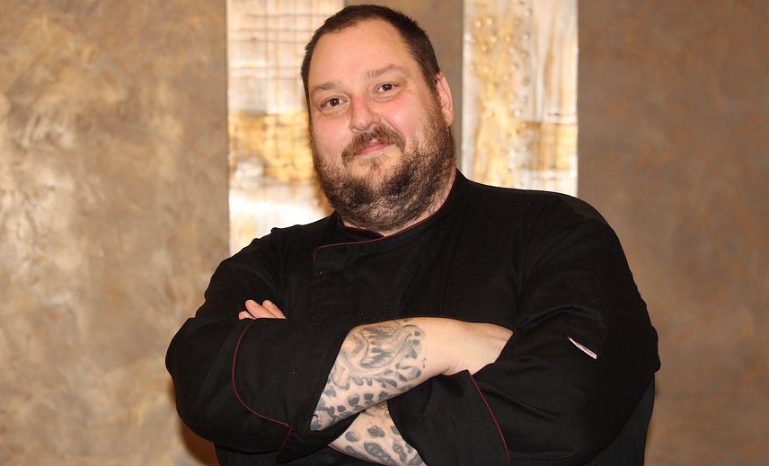 Bild: Kai Wei&szlig; in schwarzer Arbeitskleidung in seinem Restaurant