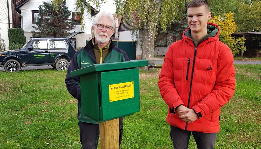 Bild: Das Team der Harzer Wandernadel ist viel im Einsatz - hier beim Aufstellen des neuen Kastens in Elende.