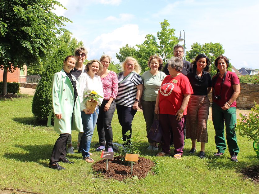 Fr&ouml;hliche G&auml;stef&uuml;hrer mit Kurdirektorin und G&auml;rtnerin gratulieren Anja Klement (mit Blumentopf) zu ihrem besondren Geburtstag (Foto: oas)